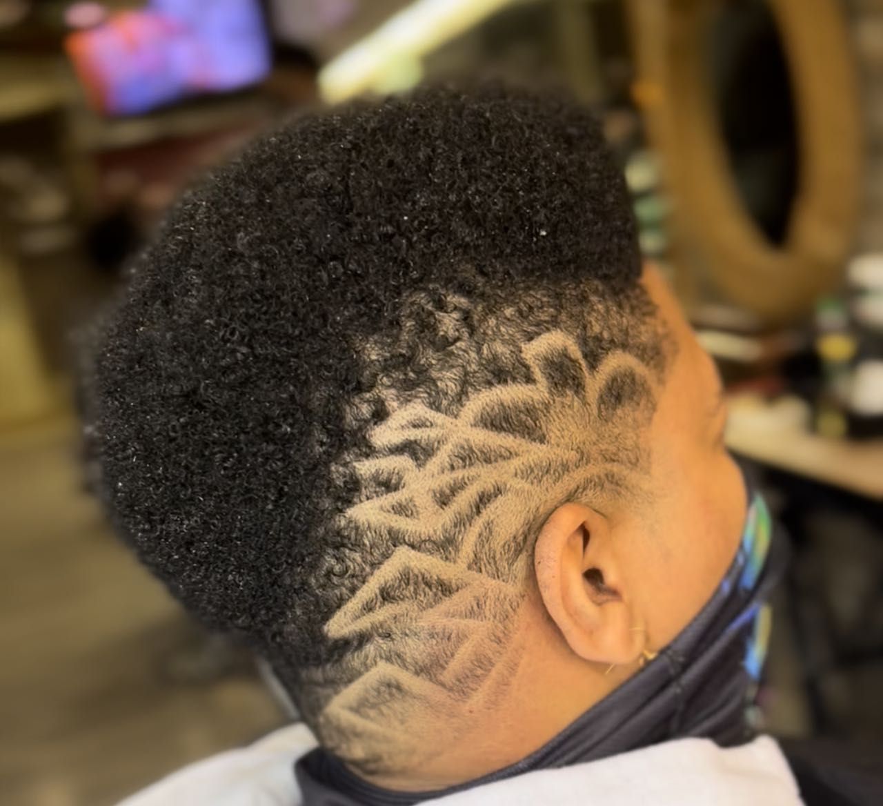 Barber styling a client haircut at Figs Barber Shop